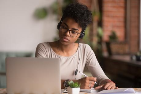 female student in front of a laptop