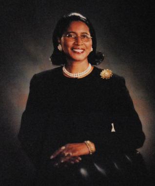 Glendell查德威克 standing behind a chair